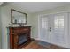 Living area featuring an electric fireplace with wood laminate floors and a doorway to another room at 403 Saint Petersburg W Dr, Oldsmar, FL 34677