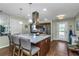 Eat-in kitchen with island seating, stainless appliances, and modern hood at 403 Saint Petersburg W Dr, Oldsmar, FL 34677