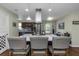 Bright eat-in kitchen with stainless appliances, large island with modern hood, and barstool seating at 403 Saint Petersburg W Dr, Oldsmar, FL 34677