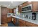 A kitchen with stainless steel appliances, wooden cabinets and a stylish backsplash at 403 Saint Petersburg W Dr, Oldsmar, FL 34677