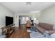 Spacious living room with hardwood floors, neutral walls, and comfortable seating at 403 Saint Petersburg W Dr, Oldsmar, FL 34677