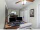 Cozy office featuring a fireplace, a ceiling fan with lights, and a wooden desk at 403 Saint Petersburg W Dr, Oldsmar, FL 34677