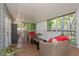 A cozy covered porch featuring comfortable seating and an outdoor garden view at 403 Saint Petersburg W Dr, Oldsmar, FL 34677