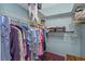 Organized walk-in closet with shelves and hanging racks providing ample storage for clothes and accessories at 403 Saint Petersburg W Dr, Oldsmar, FL 34677