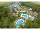 Stunning aerial view of the community's resort-style amenities, lush landscaping, and sparkling pool at 4224 Crayford Ct, Land O Lakes, FL 34638