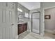 Bathroom features granite vanity, walk-in shower with glass doors, and modern fixtures at 4224 Crayford Ct, Land O Lakes, FL 34638