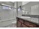 Bathroom featuring a shower, toilet, granite counters, and wood cabinets at 4224 Crayford Ct, Land O Lakes, FL 34638