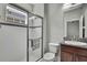 Modern bathroom with a glass-enclosed shower, granite vanity, and neutral color palette at 4224 Crayford Ct, Land O Lakes, FL 34638