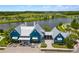 Stunning blue clubhouse overlooking a serene lake, complete with bike racks and inviting benches at 4224 Crayford Ct, Land O Lakes, FL 34638