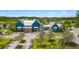 Gorgeous blue clubhouse with metal roof, landscaping and plenty of seating for visitors at 4224 Crayford Ct, Land O Lakes, FL 34638