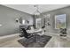 Contemporary dining room with sleek table, stylish chairs, geometric chandelier, and mirrored accents at 4224 Crayford Ct, Land O Lakes, FL 34638