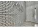 Inviting entryway features stylish brick wall and modern light fixtures at 4224 Crayford Ct, Land O Lakes, FL 34638