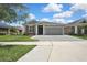 Beautiful one-story home featuring a two-car garage and a well-manicured lawn at 4224 Crayford Ct, Land O Lakes, FL 34638
