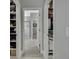 Hallway view showcasing walk-in closets and a bathroom, offering ample storage space at 4224 Crayford Ct, Land O Lakes, FL 34638