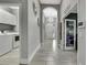 Hallway showing access to the laundry room and media room; tile flooring throughout at 4224 Crayford Ct, Land O Lakes, FL 34638