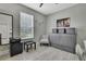 Bright office space with a murphy bed, stylish chair, and ample natural light at 4224 Crayford Ct, Land O Lakes, FL 34638