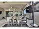 Spacious outdoor kitchen with stainless steel appliances, bar seating, and TV at 4224 Crayford Ct, Land O Lakes, FL 34638