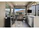 Outdoor kitchen featuring stainless steel appliances, built-in grill, mini fridge, sink, and expansive counter space for entertaining at 4224 Crayford Ct, Land O Lakes, FL 34638