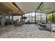 Extended, covered outdoor space complete with kitchen, dining, TV, and lounge areas at 4224 Crayford Ct, Land O Lakes, FL 34638