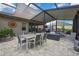 This screened patio offers a blend of outdoor seating, dining, and sun protection for the ultimate relaxation and enjoyment at 4224 Crayford Ct, Land O Lakes, FL 34638