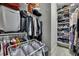 Walk-in closet with custom shelving, and hanging racks, designed for optimal organization at 4224 Crayford Ct, Land O Lakes, FL 34638