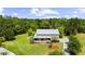 Picturesque aerial view showcasing this secluded two-story home surrounded by lush greenery and mature trees at 4702 Cypress Serenity Dr, Plant City, FL 33565
