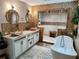 Luxurious bathroom showcasing a soaking tub, decorative tile, walk-in shower and double sink vanity at 4702 Cypress Serenity Dr, Plant City, FL 33565