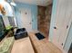 Bright bathroom featuring a tiled walk-in shower, a decorative sink and vanity and a door to the toilet room at 4702 Cypress Serenity Dr, Plant City, FL 33565