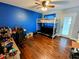 Comfortable bedroom with hardwood floors, bunkbeds, ceiling fan, and ample natural light at 4702 Cypress Serenity Dr, Plant City, FL 33565