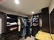 Spacious walk-in closet featuring custom shelving, drawers, and ample storage space for clothing and accessories at 4702 Cypress Serenity Dr, Plant City, FL 33565