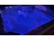 A close view of a built-in hot tub with mood lighting, set in an outdoor setting at 4702 Cypress Serenity Dr, Plant City, FL 33565