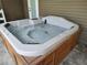 A close view of a built-in hot tub with neutral colors, set in an outdoor setting at 4702 Cypress Serenity Dr, Plant City, FL 33565