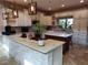 Kitchen boasts an island, modern lighting fixtures, and tile backsplash at 4702 Cypress Serenity Dr, Plant City, FL 33565