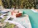 Modern pool design featuring unique water features, perfect for relaxing and enjoying the outdoors at 4702 Cypress Serenity Dr, Plant City, FL 33565