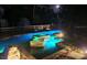 Stunning nighttime view of a custom pool and spa featuring mood lighting and a tranquil setting at 4702 Cypress Serenity Dr, Plant City, FL 33565