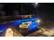 Stunning nighttime view of a custom pool and spa featuring mood lighting and a tranquil setting at 4702 Cypress Serenity Dr, Plant City, FL 33565