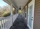 Covered front porch with neutral siding, and railing at 4702 Cypress Serenity Dr, Plant City, FL 33565