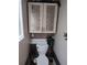 Stylish powder room with toilet, decorated cabinet and a mosaic backsplash at 4702 Cypress Serenity Dr, Plant City, FL 33565