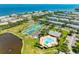 Aerial view of tennis courts and community pool surrounded by lush landscaping and residences at 4740 Beach Se Dr # A, St Petersburg, FL 33705