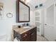 Bathroom featuring granite countertop, vanity and framed mirror at 4740 Beach Se Dr # A, St Petersburg, FL 33705