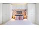 Cozy bedroom featuring built-in wardrobe and a patterned accent wall with decorative pillows at 4740 Beach Se Dr # A, St Petersburg, FL 33705