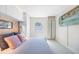 Bright bedroom with built-in closets, comfortable bed, and a view from the window at 4740 Beach Se Dr # A, St Petersburg, FL 33705