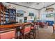 Clubhouse bar with liquor, stools, TVs, nautical decor, and tables overlooking the water at Coquina Key at 4740 Beach Se Dr # A, St Petersburg, FL 33705