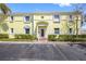 Charming yellow condo building with classic architectural details, well-maintained landscaping, and ample parking at 4740 Beach Se Dr # A, St Petersburg, FL 33705
