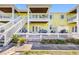 Bright yellow condo with multiple balconies and outdoor spaces, offering a vibrant coastal living experience at 4740 Beach Se Dr # A, St Petersburg, FL 33705
