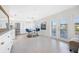 Open kitchen with modern white cabinets, stainless steel appliances, and breakfast bar at 4740 Beach Se Dr # A, St Petersburg, FL 33705