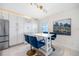 Bright kitchen features white cabinets, stainless steel appliances, and stylish breakfast bar with blue velvet chairs at 4740 Beach Se Dr # A, St Petersburg, FL 33705