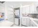 Convenient laundry area featuring a stacked washer and dryer, next to the kitchen at 4740 Beach Se Dr # A, St Petersburg, FL 33705