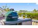 Outdoor kitchen featuring a Big Green Egg grill and champagne setup, perfect for entertaining by the water at 4740 Beach Se Dr # A, St Petersburg, FL 33705