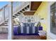 Comfortable outdoor lounge area under the stairs with stylish pillows and a unique compass decoration at 4740 Beach Se Dr # A, St Petersburg, FL 33705